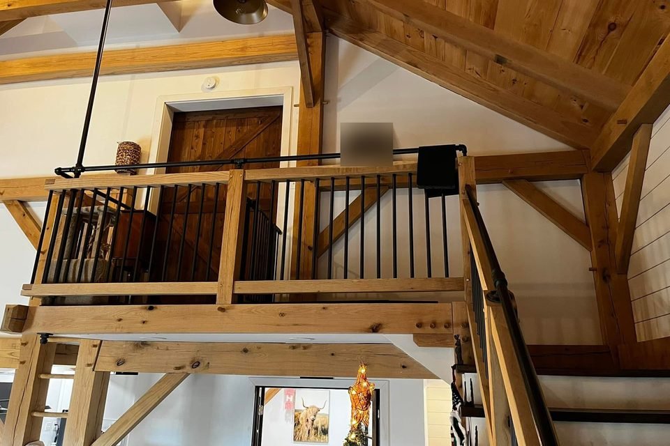 Timber framed loft with railing and staircase